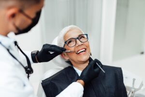 Patient and dentist discussing dental implant consultation details.