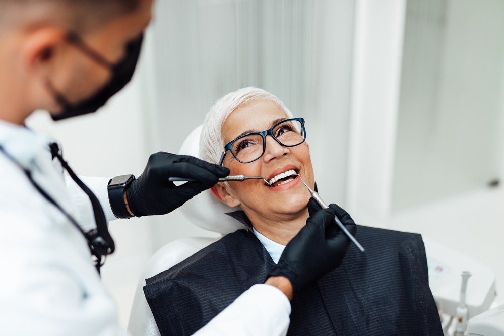 Patient and dentist discussing dental implant consultation details.