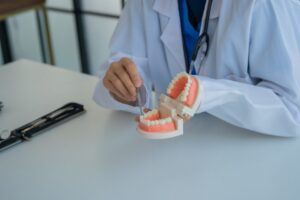 Patient consulting with dentist during first dental appointment.
